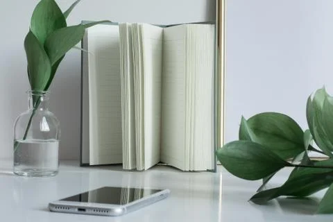 Business desktop with notebook pages vase phone Stock Photos