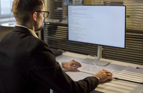 Business developer coding software on monitor in bright office workspace Stock Photos
