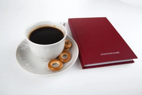 Business diary with cup of coffee  Stock Photos