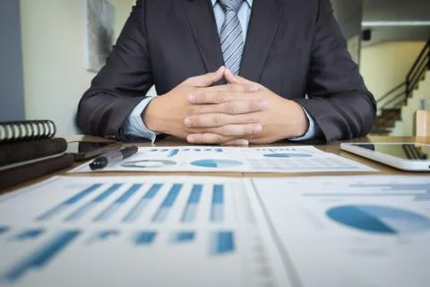 Business documents on office table with graph financial diagram and businessm Stock Photos