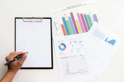 Business documents on office table with  graph financial and man working in t Foto stock