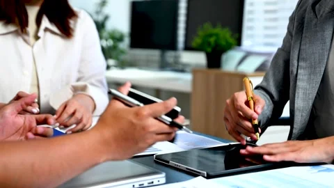 Business documents on office table with smart phone and laptop and two coll.. Stock Footage 312775258
