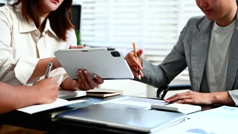 Business documents on office table with smart phone and laptop and two coll.. Stock Footage 312775273