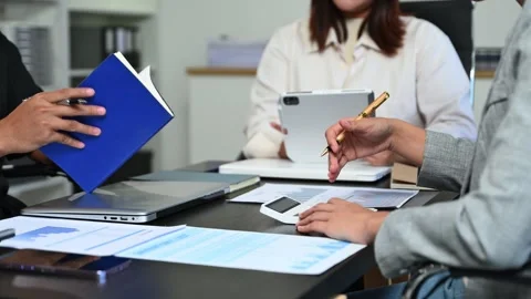 Business documents on office table with smart phone and laptop and two coll.. Stock Footage 312775285