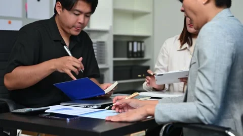 Business documents on office table with smart phone and laptop and two coll.. Stock Footage 312775305