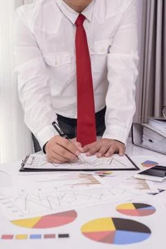 Business documents on office table with smart phone and digital tablet and ma Stock Photos