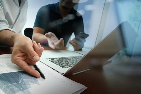 Business documents on office table with smart phone and digital tablet and .. Stock Photos