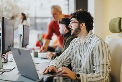 Business employees collaborating, analyzing data, and strategizing in a Stock Photos