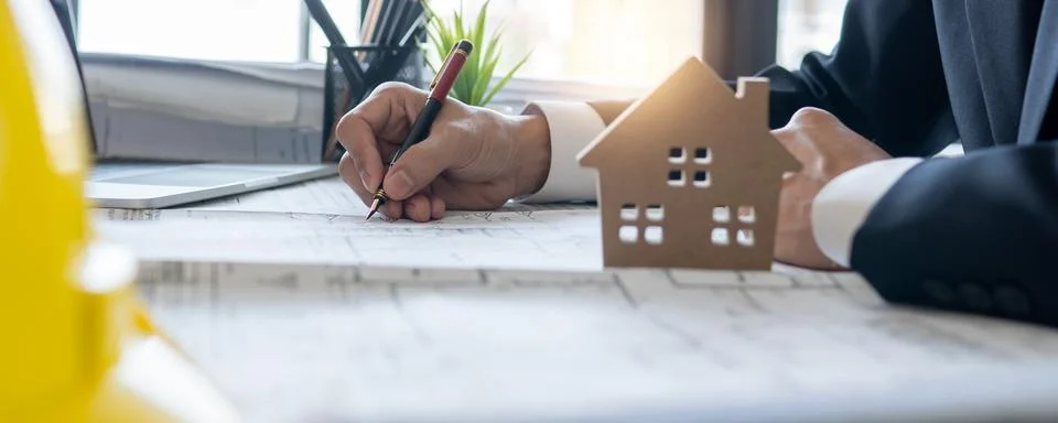 Business engineer planing and checking on blueprint on table background of .. Stock Photos