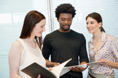 Business executives discussing documents in an office Foto stock