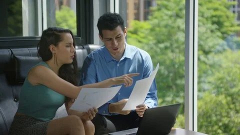 Business executives discussing over document in office Stock Footage 75451348