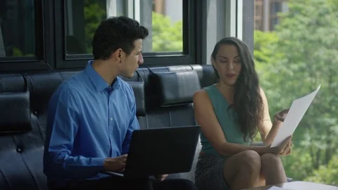 Business executives discussing over document in office Stock Footage 75451373