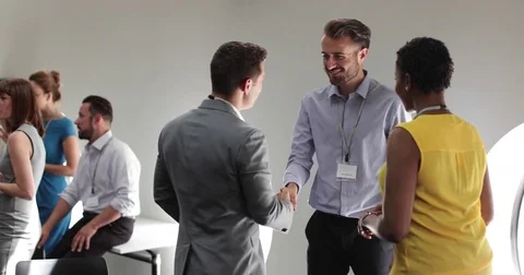 Business executives shaking hands at a networking event Video stock 79106452
