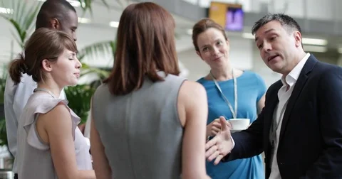 Business executives shaking hands at a networking event Stock Footage