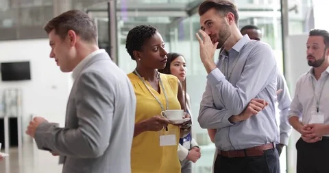 Business executives shaking hands at a networking event Stock Footage 79120057