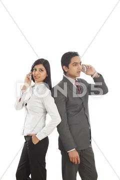 Business executives talking on mobile phones Stock Photos