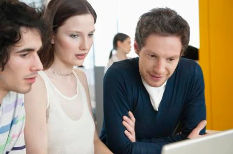 Business executives using a laptop in an office Stock Photos