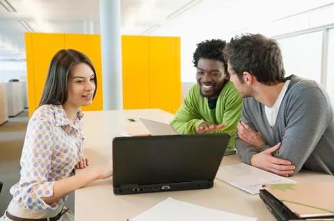 Business executives using laptops in an office Stock Photos