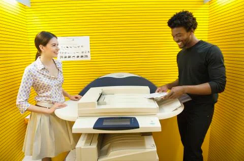 Business executives using photocopy machine in an office Stock Photos