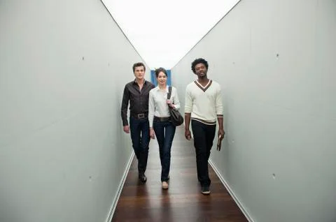 Business executives walking in the corridor of an office Stock Photos
