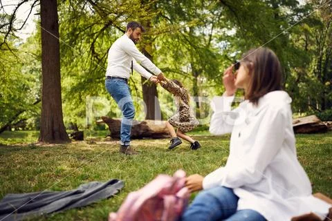 Business father spinning a daghter in park Stock Photos