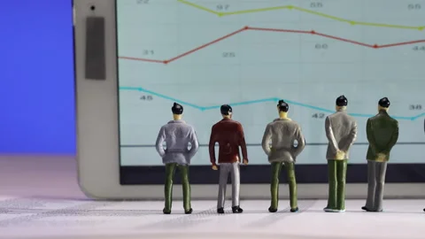 Business Figurines Watching a Chart Stock Footage 243545112