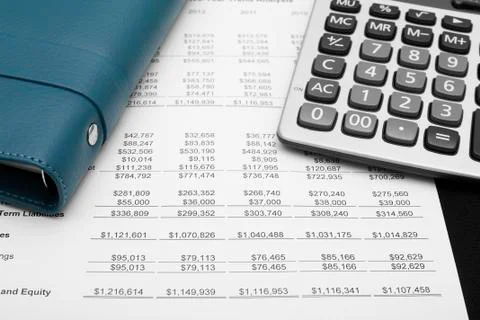 Business financial chart analysis with notebook &amp; calculator Stock Photos
