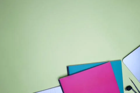 Business flat lay, office table top. Notebooks and laptop on green background Stock Photos