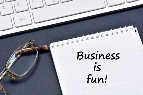 Business is fun text on notebook Stock Photos