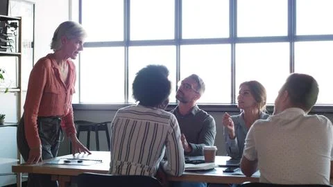 Business gets better when we work together. a group of businesspeople having a Stock Photos