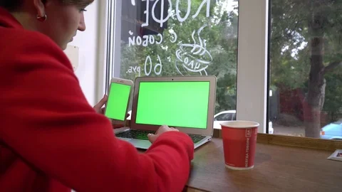 Business girl in a coffeshop, working using laptop and phone Stock Footage 80966174