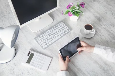 Business girl using tablet computer in office desk. Stock Photos