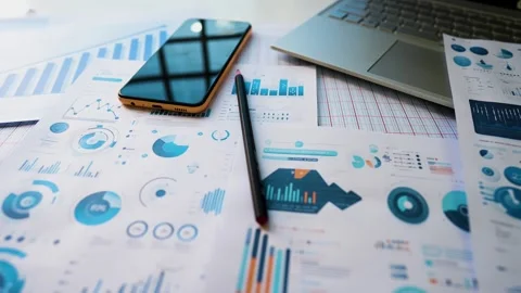 Business graph chart papers phone with laptop on white table view Stock Footage 293514812