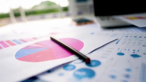 Business graph chart report papers laptop pencil view on table window near Stock Footage 293515032