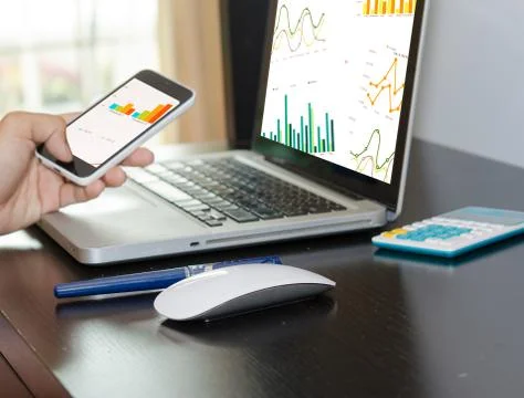 Business graph Computer and smart phone Stock Photos
