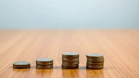 Business graph made of coins on a white background Stacks of Gold Coins Pil.. Stock Footage 272767893