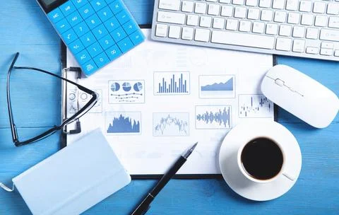 Business graphs, computer keyboard, coffee, pen, eyeglasses. Business. Analys Stock Photos