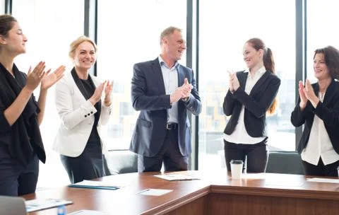 Business group clapping and smiling Stock Photos