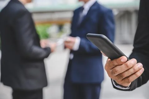 Business groups are using mobile phones to make business contacts, trade, c.. Fotos de archivo