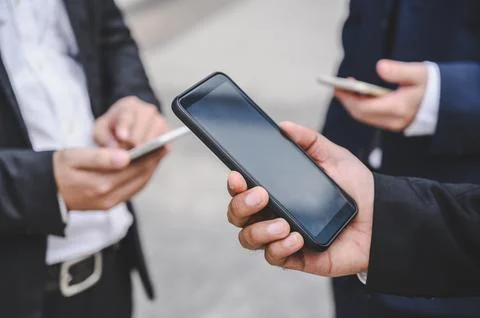Business groups are using mobile phones to make business contacts, trade, c.. Fotos de archivo