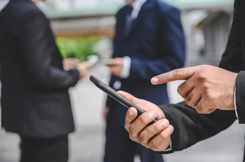 Business groups are using mobile phones to make business contacts, trade, c.. Fotos de archivo