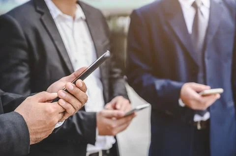 Business groups are using mobile phones to make business contacts, trade, c.. Fotos de archivo