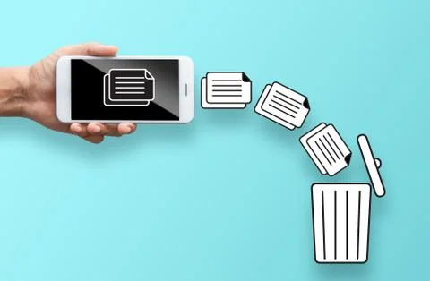 Business hand throw data file from mobile to trash bin Stock Photos