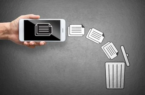 Business hand throw data file from mobile to trash bin Stock Photos
