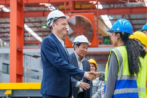 Business Handshake Between Managers and Workers in Factory Stock Photos