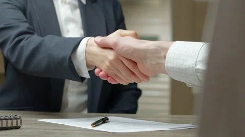 Business handshake between two partners sitting at the table. Stock Footage 263992612