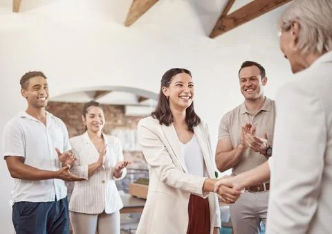 Business handshake with clapping workers in the work office. Professional Stock Photos