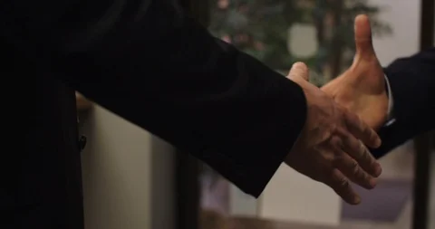 Business Handshake - two men wearing suits in office lobby Stock Footage