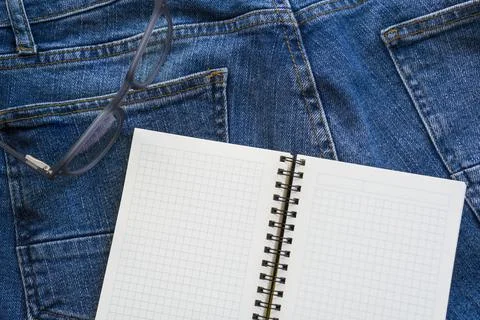 Business ideas. Notepad for notes. Jeans. Stock Photos
