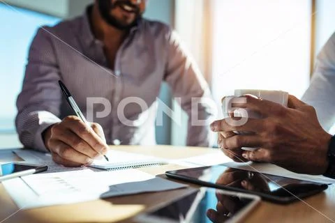 Business investors planning business sitting at table in office. Stock Photos